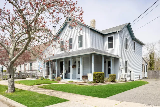 a front view of a house with a yard and plants