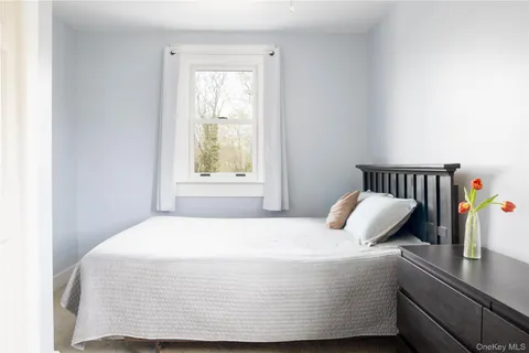 a bedroom with a bed and window