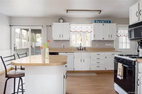 a kitchen with granite countertop a stove a sink and a cabinets