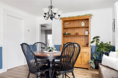 a view of a dining room with furniture and chandelier