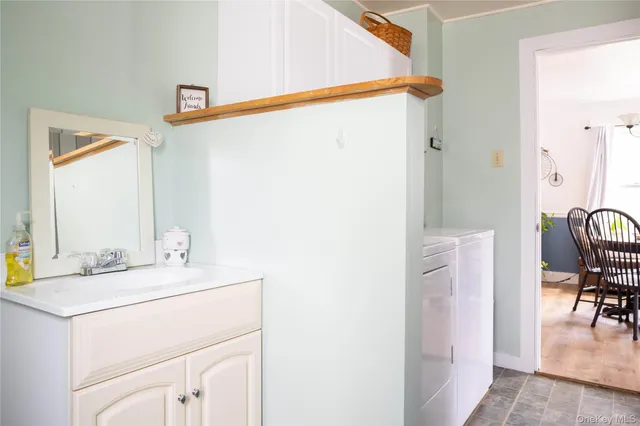 a bathroom with a sink vanity and a mirror