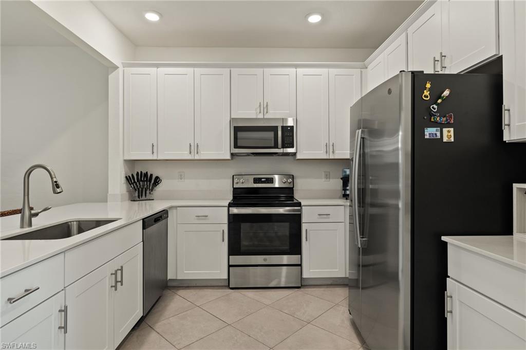 2934 Citrus Street Naples, FL 34120 - Photo 5 of 29 a kitchen with cabinets and stainless steel appliances