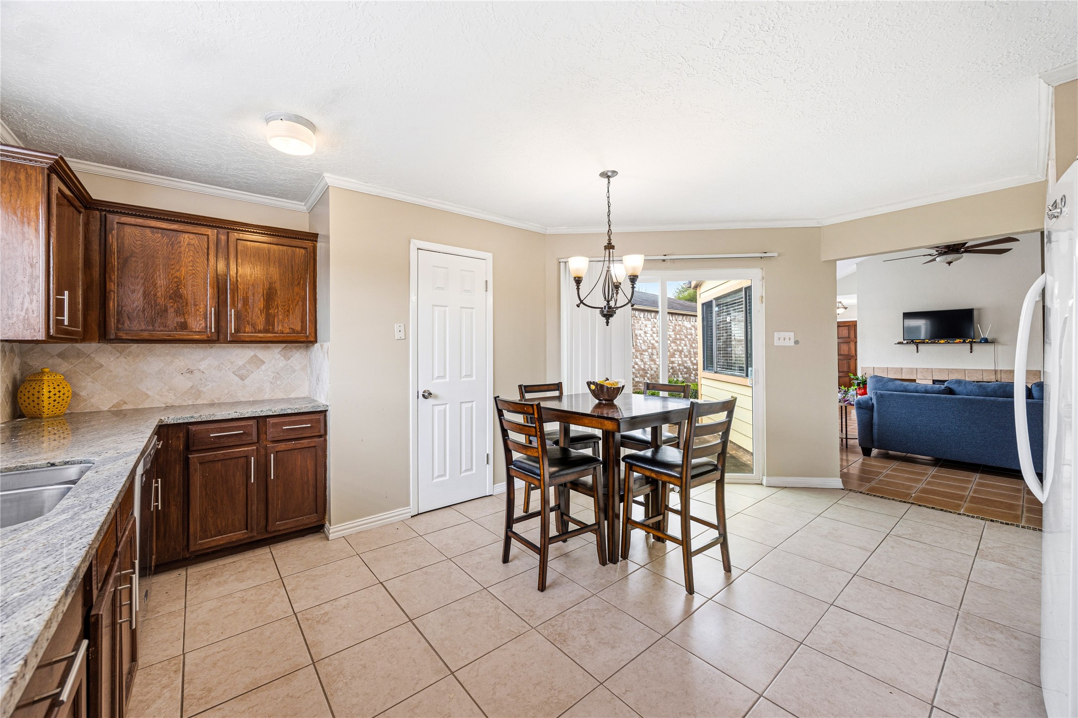 9206 Homeland Drive Houston, TX 77083 - Photo 1 of 39 a kitchen with granite countertop a sink cabinets and stainless steel appliances