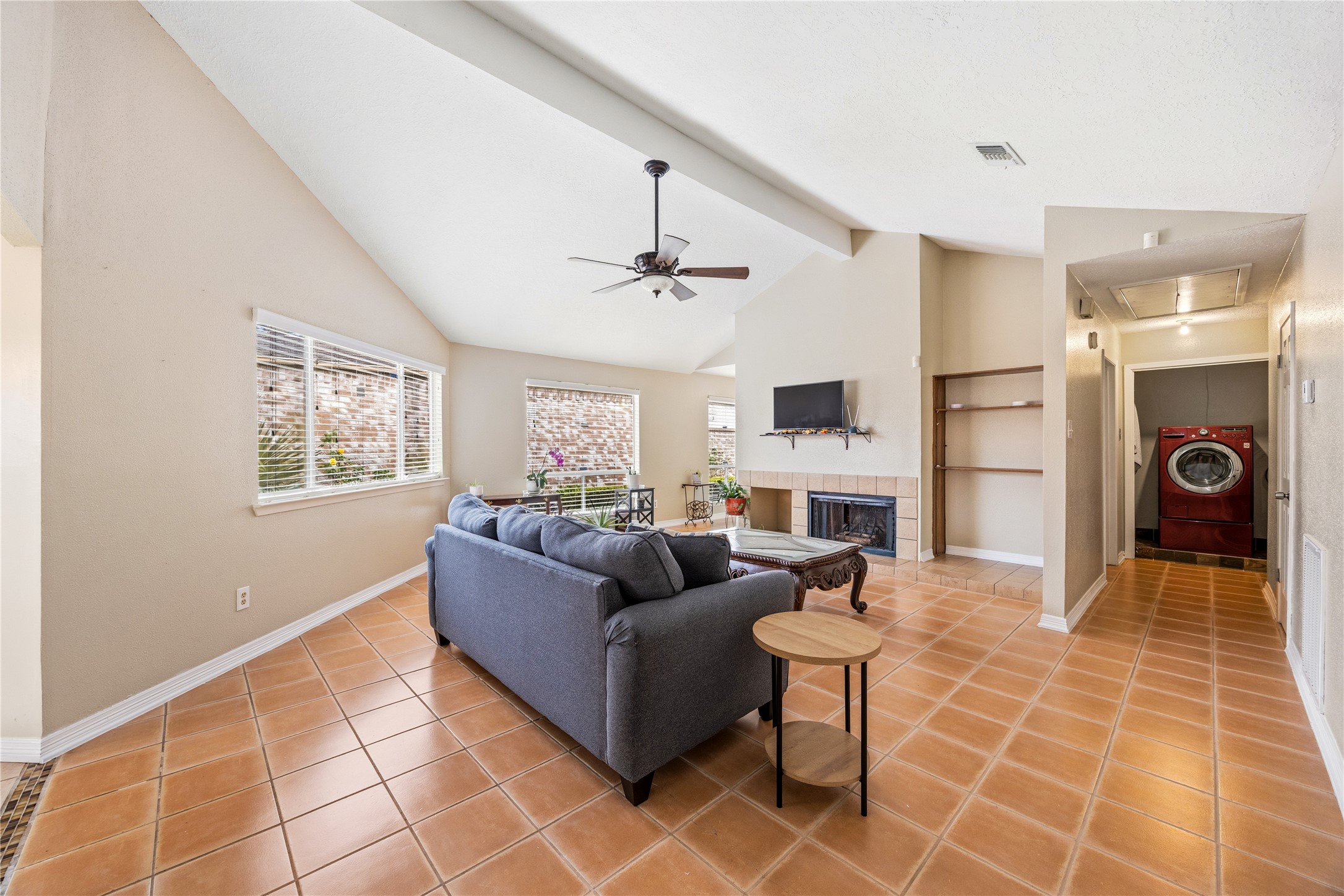 9206 Homeland Drive Houston, TX 77083 - Photo 14 of 39 a living room with couches a fireplace and a dining table with wooden floor