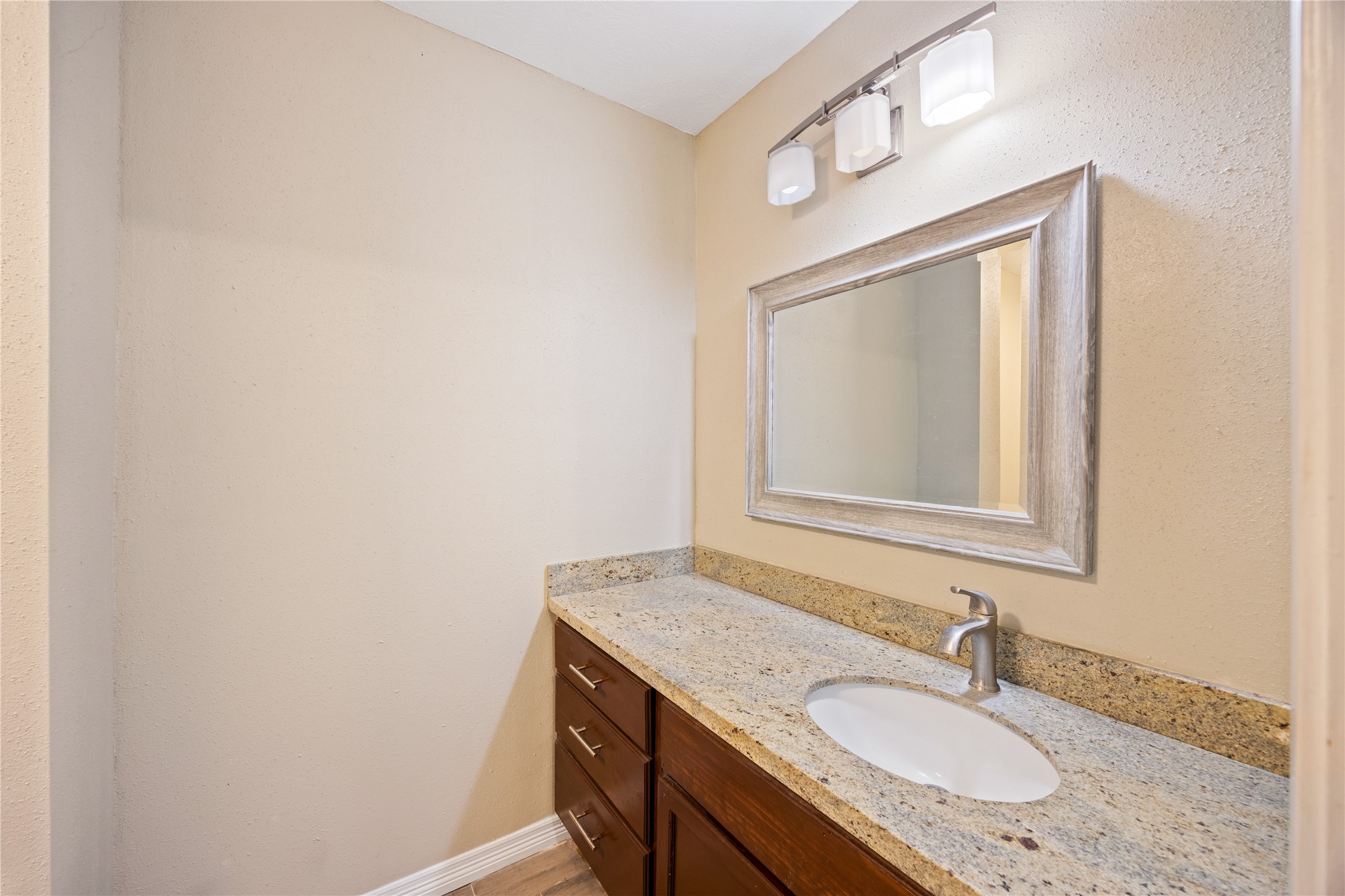 9206 Homeland Drive Houston, TX 77083 - Photo 20 of 39 a bathroom with a granite countertop sink and a mirror