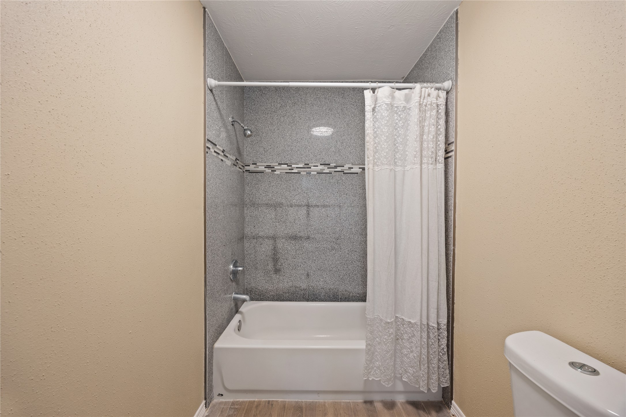 9206 Homeland Drive Houston, TX 77083 - Photo 21 of 39 a bathroom with a bathtub and a shower