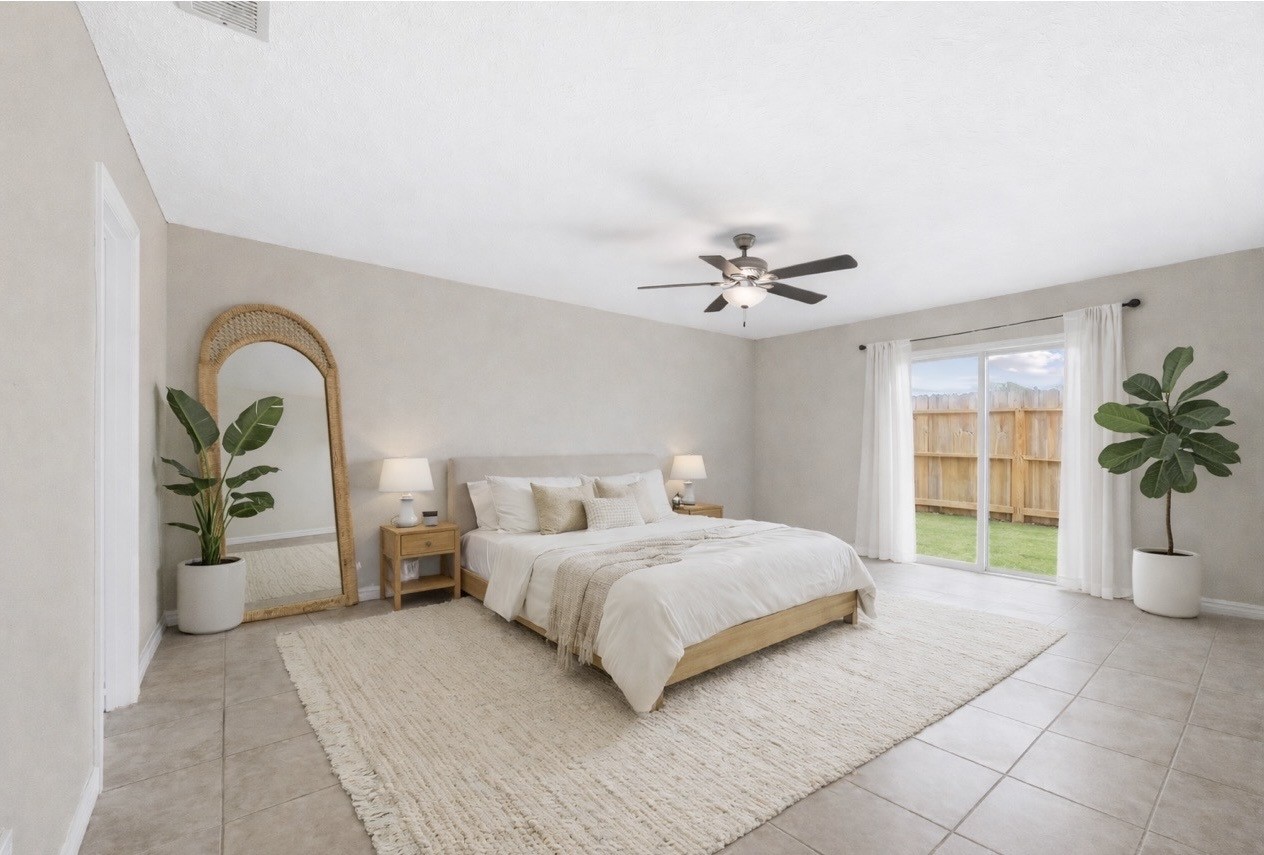 9206 Homeland Drive Houston, TX 77083 - Photo 24 of 39 a bedroom with a large bed and a window