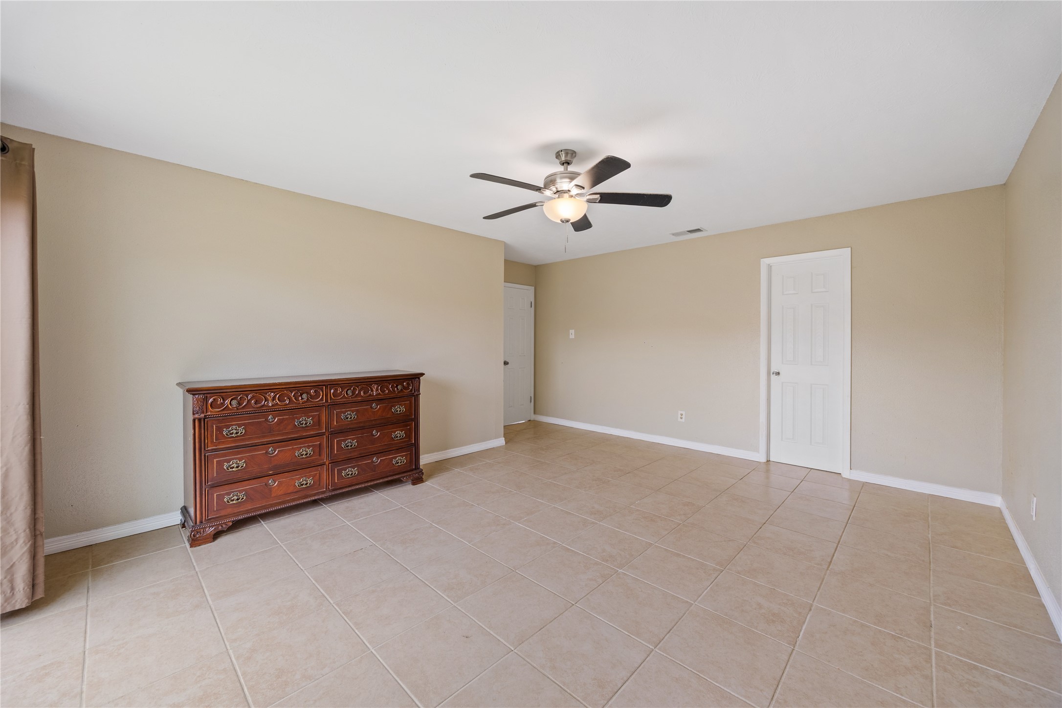 9206 Homeland Drive Houston, TX 77083 - Photo 26 of 39 a view of an empty room with a ceiling fan