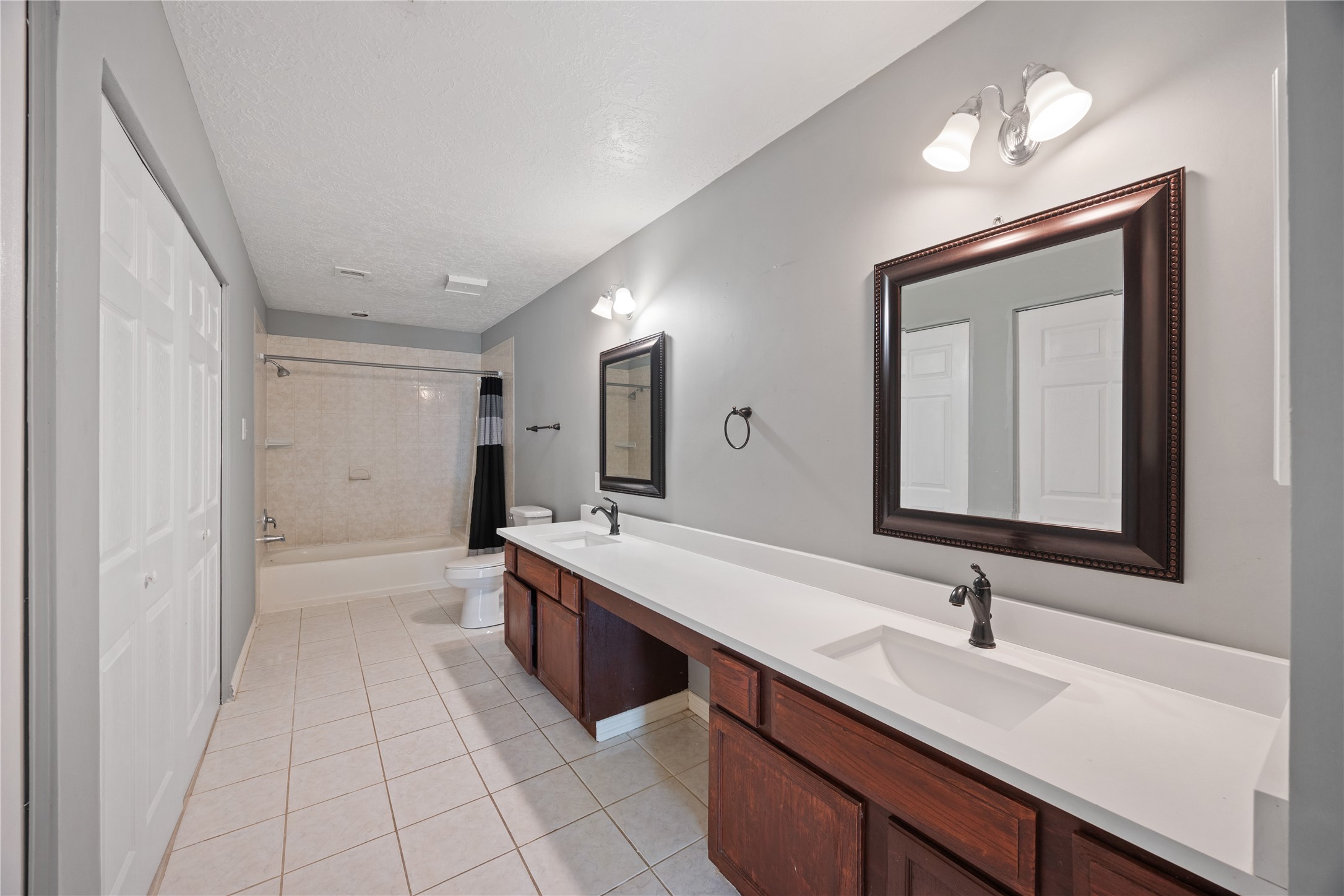 9206 Homeland Drive Houston, TX 77083 - Photo 27 of 39 a spacious bathroom with a double vanity sink mirror and a bathtub
