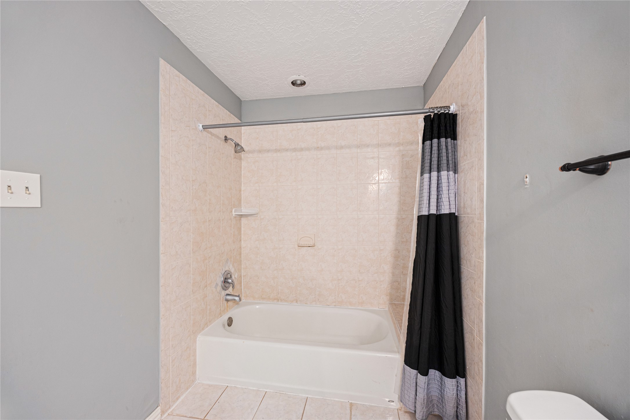 9206 Homeland Drive Houston, TX 77083 - Photo 28 of 39 a bathroom with a bathtub and a shower