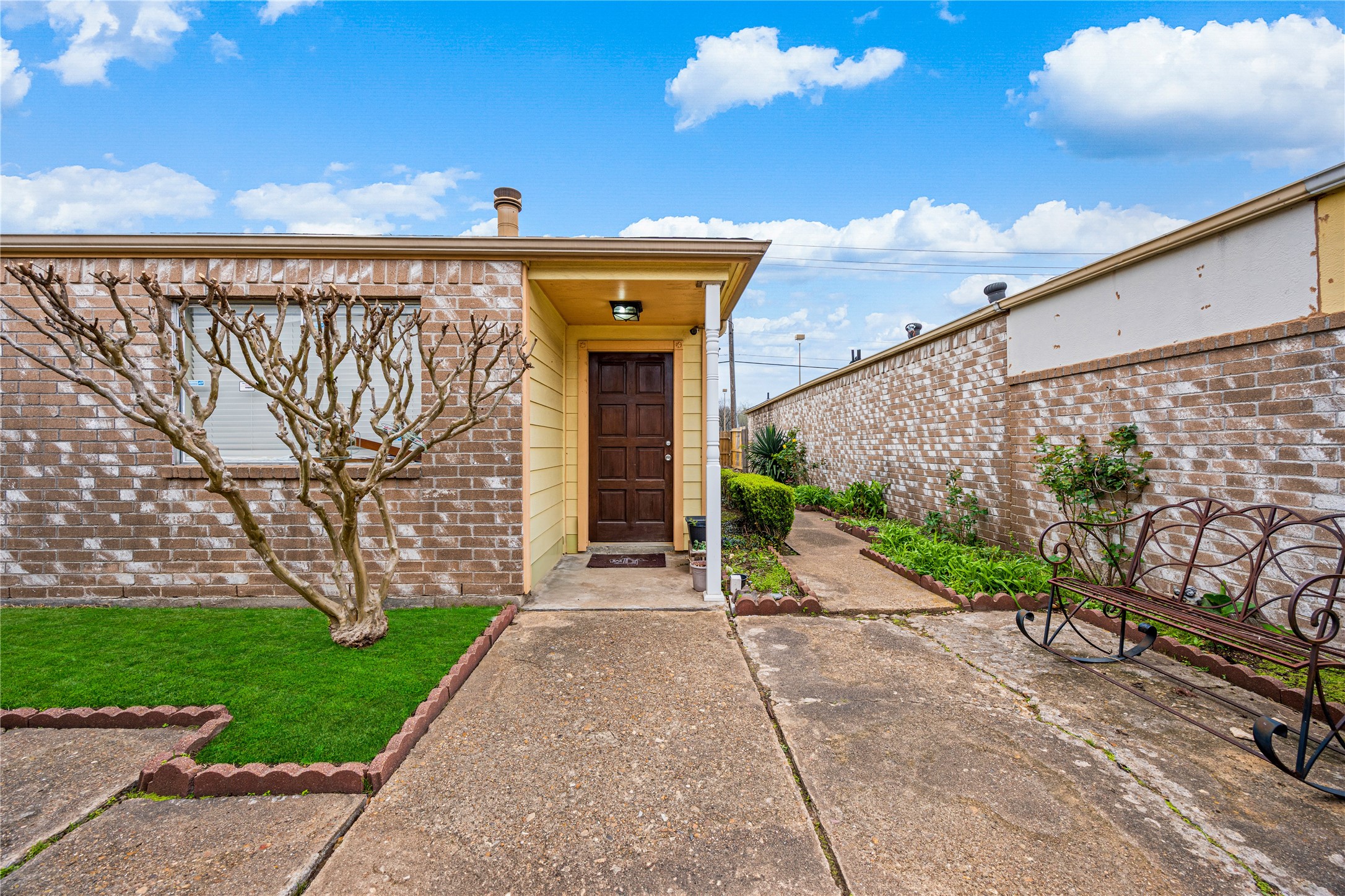 9206 Homeland Drive Houston, TX 77083 - Photo 9 of 39 a front view of a house with a garden and pathway