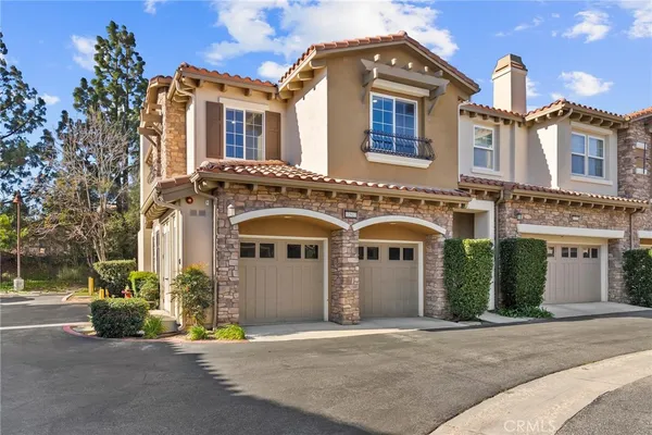 a front view of a house with a yard and outdoor seating