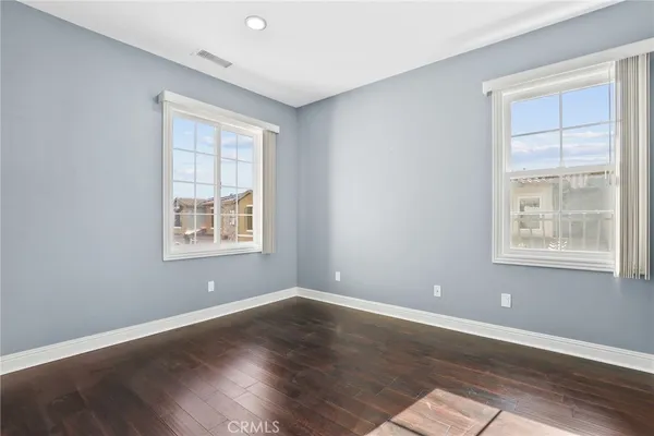 a living room with hard wood floors and a couch