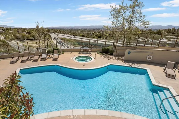 a view of a swimming pool with outdoor seating