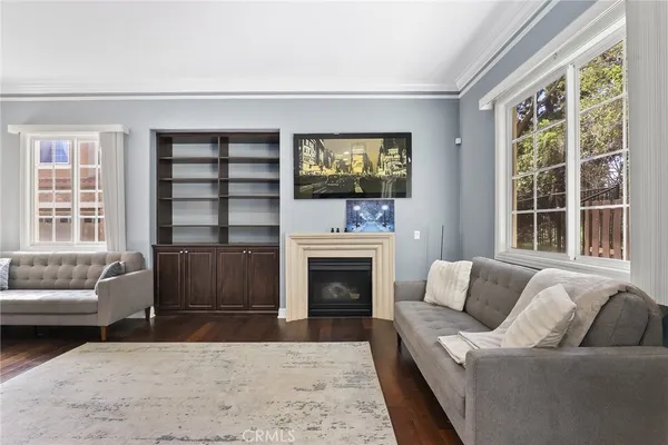 a view of a a dining room with furniture window and wooden floor