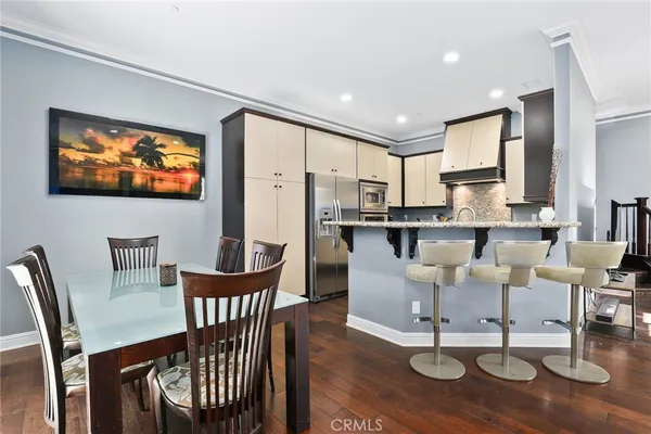 a kitchen with granite countertop white cabinets sink and stainless steel appliances