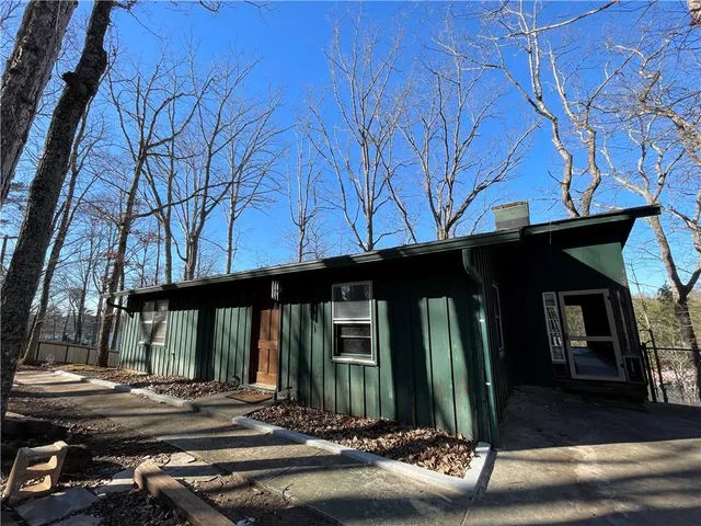 a house view with a tree in front of it