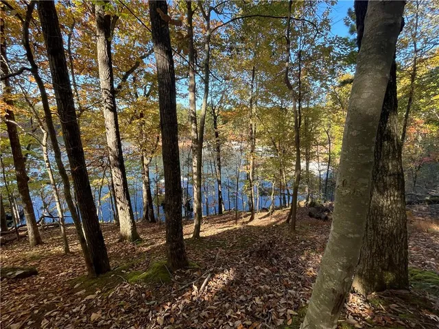 a lake view with a sitting space and a table