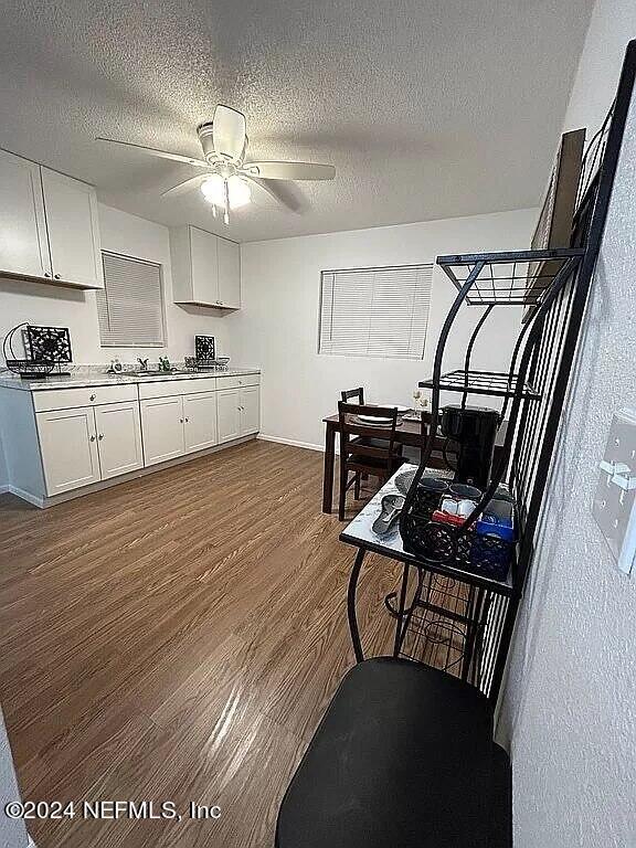 104 Dickens Street Interlachen, FL 32148 - Photo 12 of 24 a kitchen with furniture wooden floor and a appliances