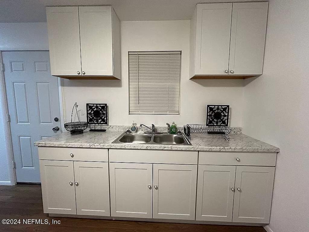 104 Dickens Street Interlachen, FL 32148 - Photo 16 of 24 a kitchen with white cabinets and sink