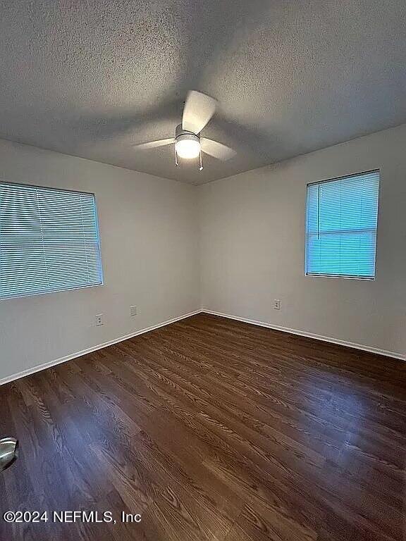 104 Dickens Street Interlachen, FL 32148 - Photo 18 of 24 a view of an empty room with wooden floor and a window