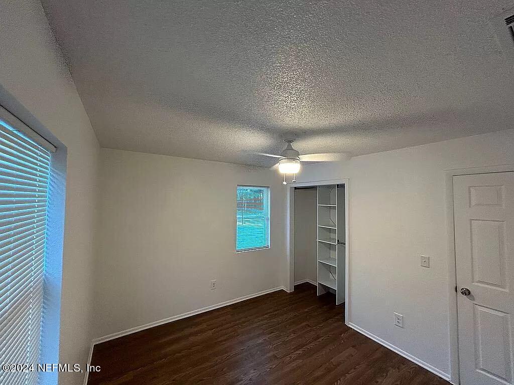104 Dickens Street Interlachen, FL 32148 - Photo 19 of 24 an empty room with wooden floor and windows