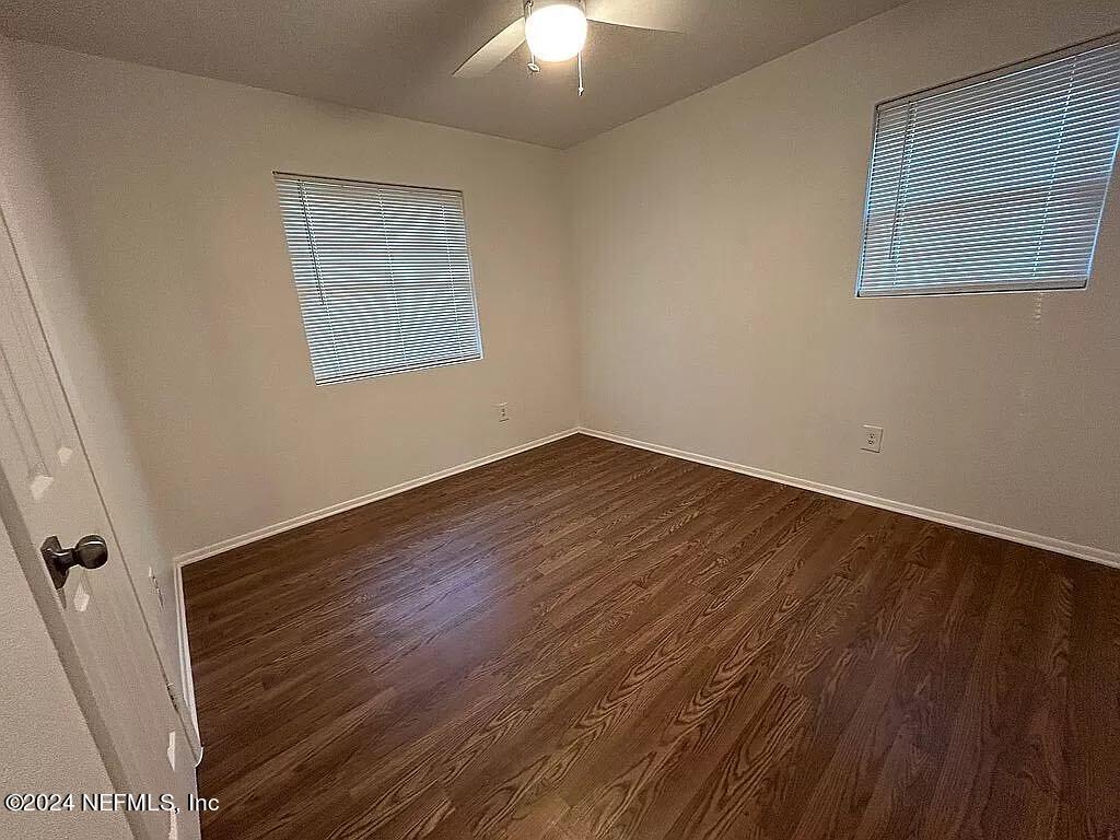104 Dickens Street Interlachen, FL 32148 - Photo 20 of 24 a view of an empty room with wooden floor and a window