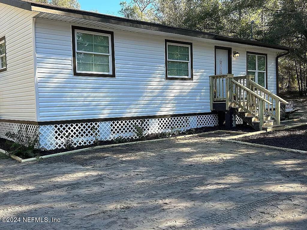 104 Dickens Street Interlachen, FL 32148 - Photo 2 of 24 a view of a house with a small yard