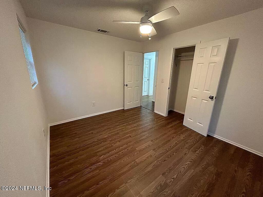 104 Dickens Street Interlachen, FL 32148 - Photo 21 of 24 an empty room with wooden floor and window