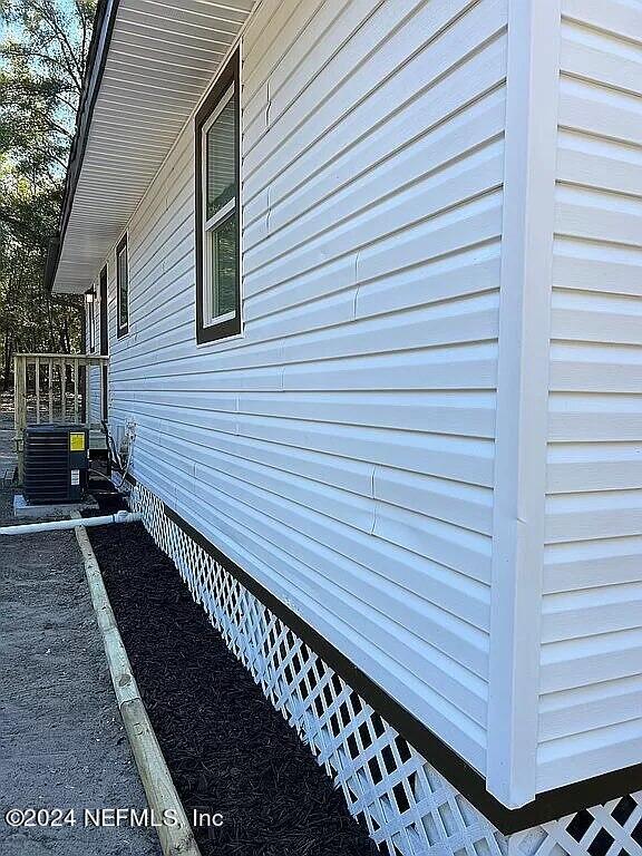 104 Dickens Street Interlachen, FL 32148 - Photo 4 of 24 a view of a balcony with wooden floor