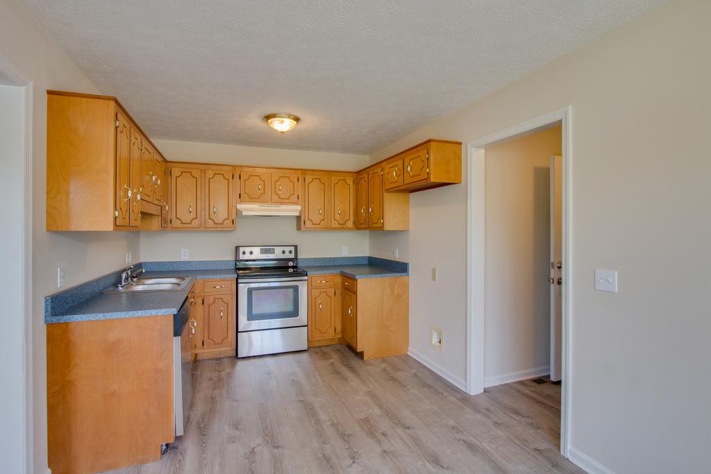 296 Old Shannon Road Lebanon, TN 37090 - Photo 11 of 30 a kitchen with stainless steel appliances granite countertop a stove a sink and a refrigerator