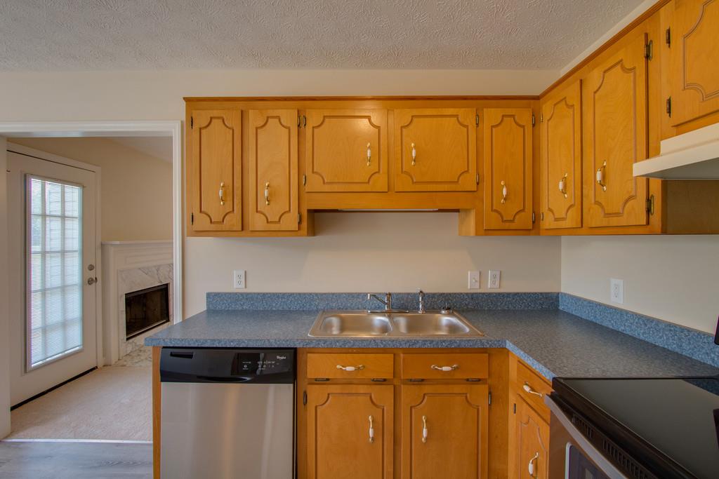 296 Old Shannon Road Lebanon, TN 37090 - Photo 12 of 30 a kitchen with stainless steel appliances granite countertop a sink a stove cabinets and wooden floor