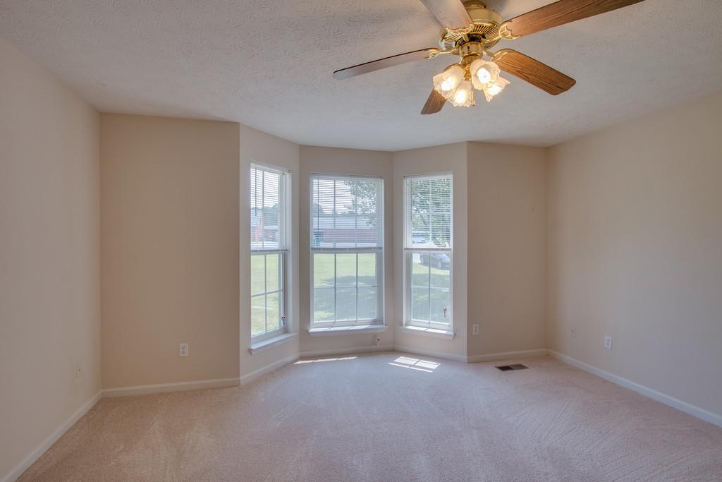 296 Old Shannon Road Lebanon, TN 37090 - Photo 18 of 30 an empty room with windows and chandelier fan