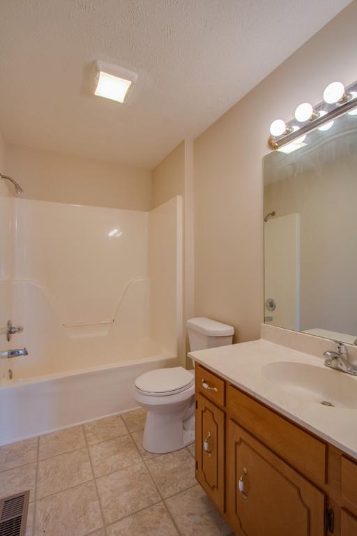 296 Old Shannon Road Lebanon, TN 37090 - Photo 21 of 30 a bathroom with a granite countertop sink a toilet and a mirror