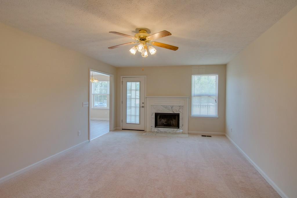 296 Old Shannon Road Lebanon, TN 37090 - Photo 7 of 30 an empty room with windows and fireplace
