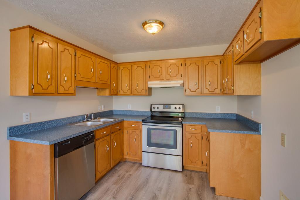 296 Old Shannon Road Lebanon, TN 37090 - Photo 10 of 30 a kitchen with stainless steel appliances granite countertop a stove a sink and a microwave