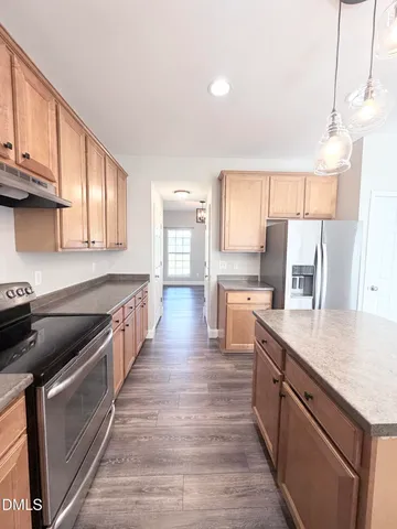 a open kitchen with stainless steel appliances granite countertop a stove a sink dishwasher and microwave with wooden floor