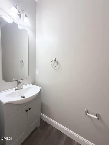 a bathroom with a sink mirror and vanity