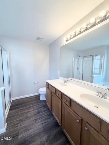 a spacious bathroom with a double vanity sink and a mirror