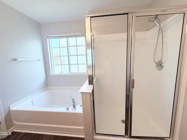a bathroom with a bathtub and a shower