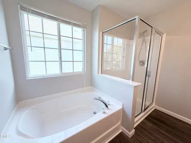 a white bath tub sitting next to a window