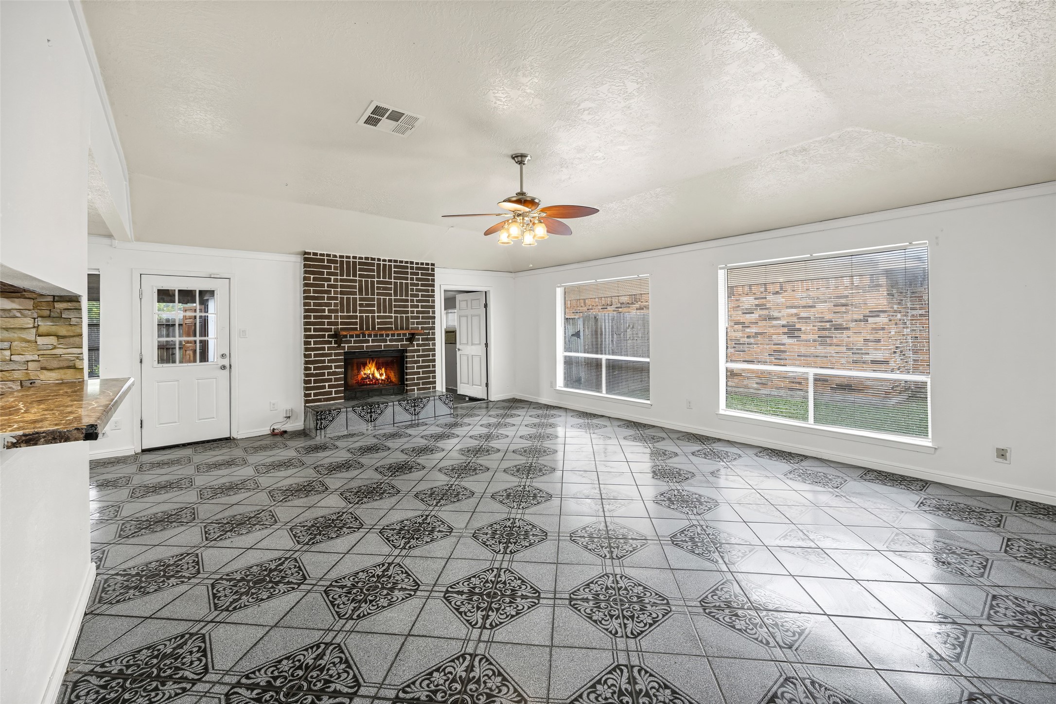7226 Ridgeberry Drive Houston, TX 77095 - Photo 3 of 31 an empty room with windows and fireplace