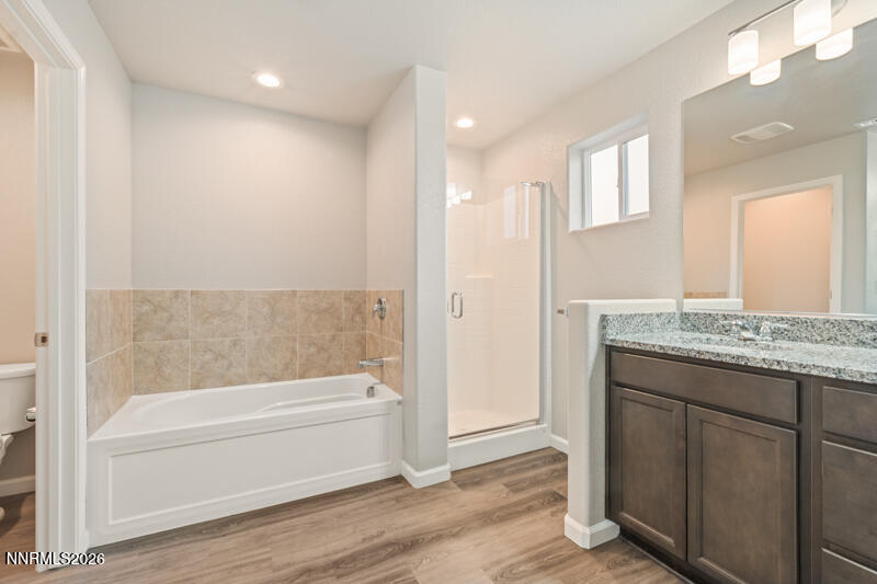 3622 Ruidoso Street Reno, NV 89512 - Photo 12 of 16 a bathroom with a granite countertop bathtub shower and sink