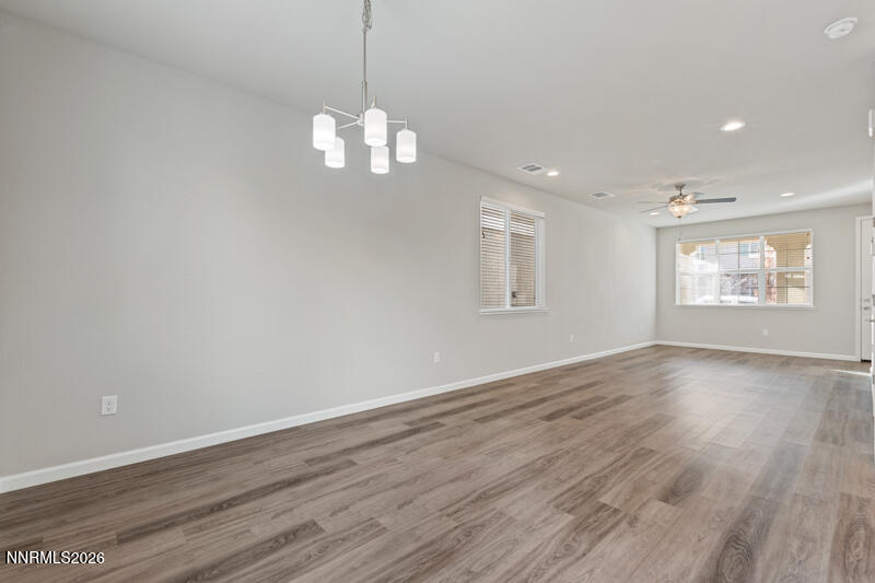 3622 Ruidoso Street Reno, NV 89512 - Photo 4 of 16 an empty room with wooden floor and windows
