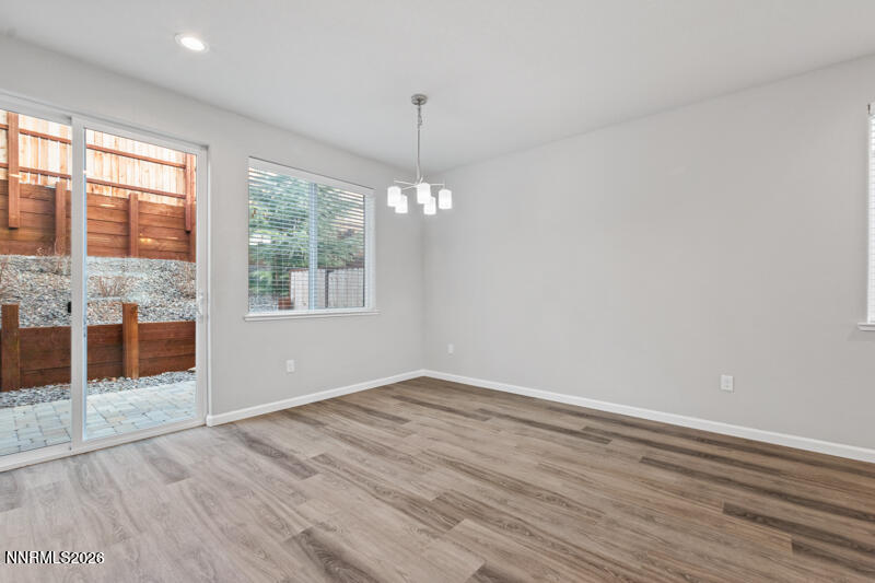3622 Ruidoso Street Reno, NV 89512 - Photo 8 of 16 a view of an empty room with wooden floor and a window
