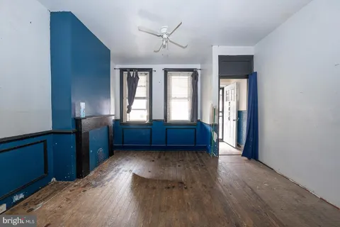 a view of entryway with wooden floor and a cabinet