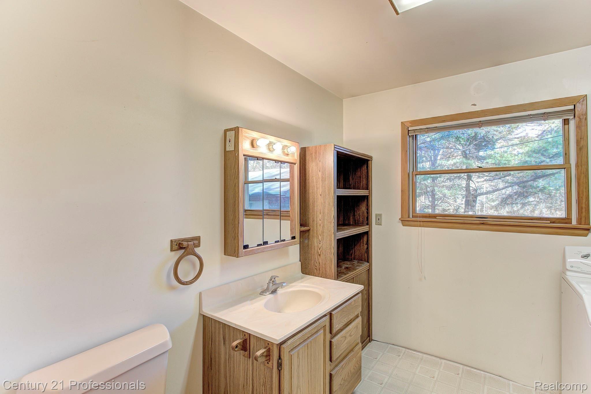 5252 Pleasant Lake Road Howell, MI 48843 - Photo 30 of 41 In-law Suite bathroom and laundry