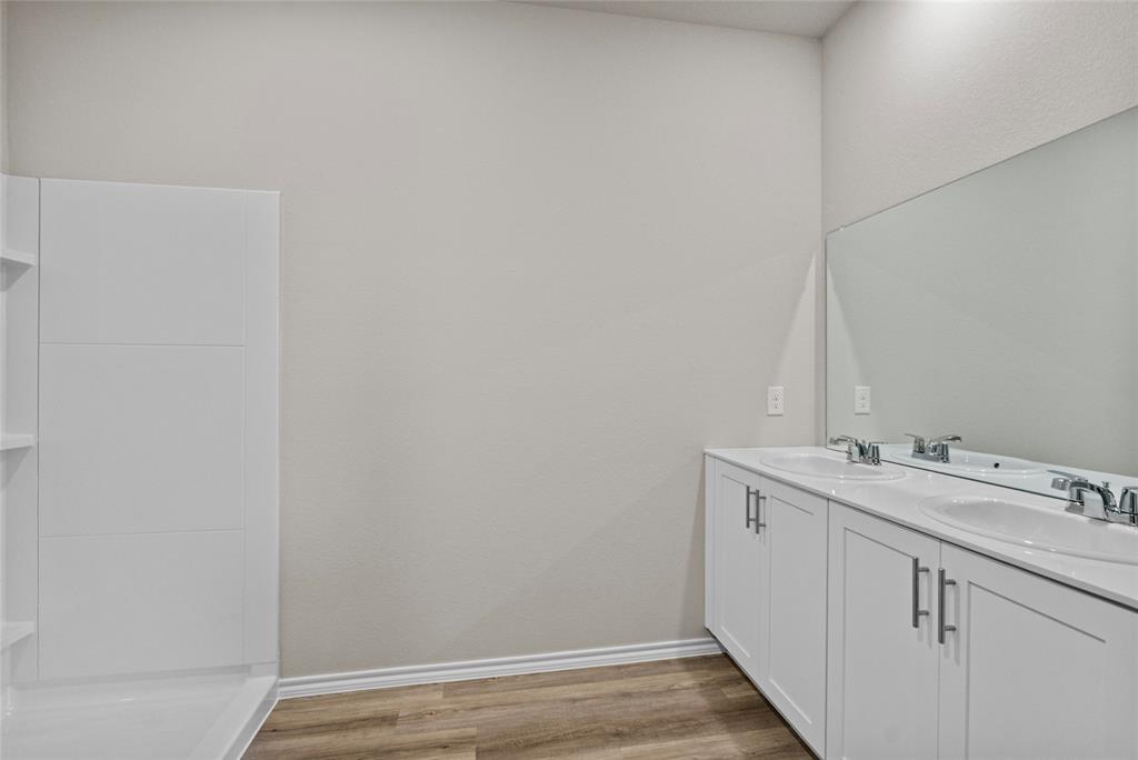 904 Traction Trail Cleburne, TX 76031 - Photo 14 of 27 a bathroom with a sink and vanity