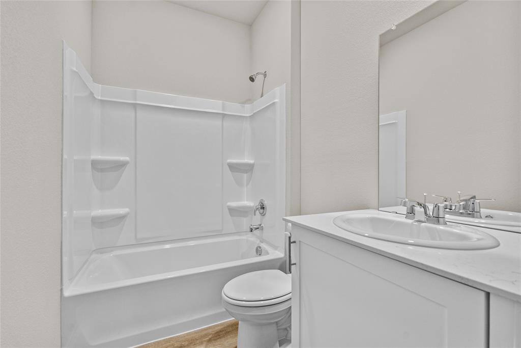 904 Traction Trail Cleburne, TX 76031 - Photo 18 of 27 a bathroom with a sink a toilet and a bathtub