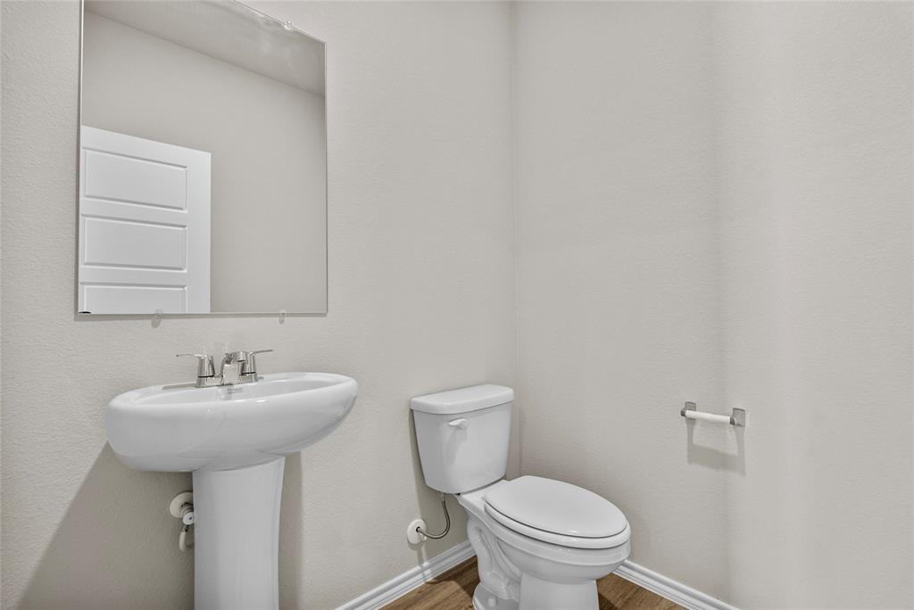 904 Traction Trail Cleburne, TX 76031 - Photo 23 of 27 a bathroom with a sink toilet and a mirror
